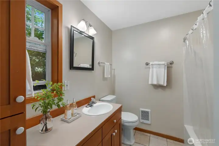 Full bath with washer & dryer tucked away for convenience.
