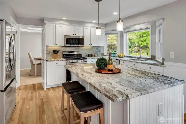 Chef's kitchen with new stainless steel appliances.