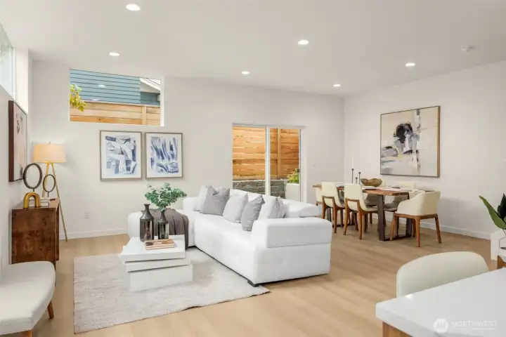 A wall of windows bathes this airy living space in natural light, inviting slow mornings, lively evenings, and everything in between.