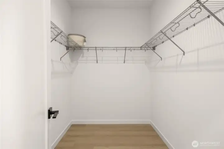 An organized dream space with room for all seasons, beautifully lit and perfectly placed just off the primary suite.