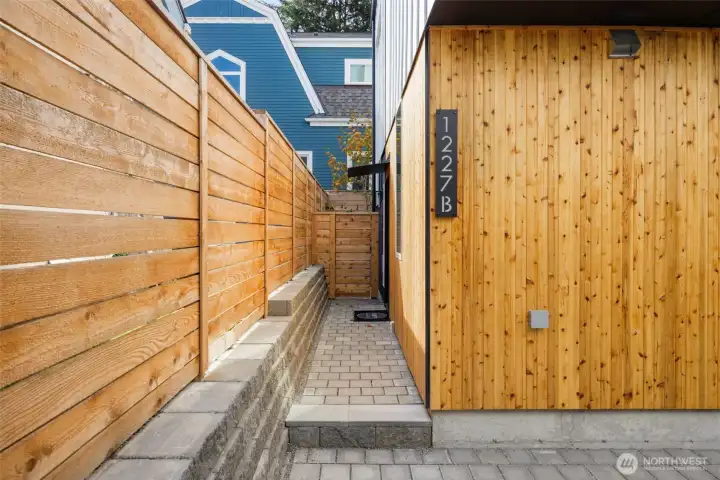 A cedar-lined walkway leads to your private entry—modern craftsmanship in every board and brick.