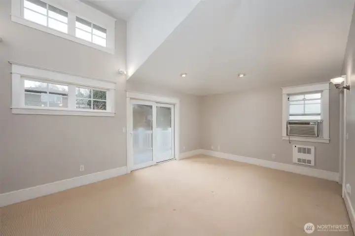 Primary suite with private deck and sliding glass doors, walk in closet, vaulted ceilings and 5 piece bathroom