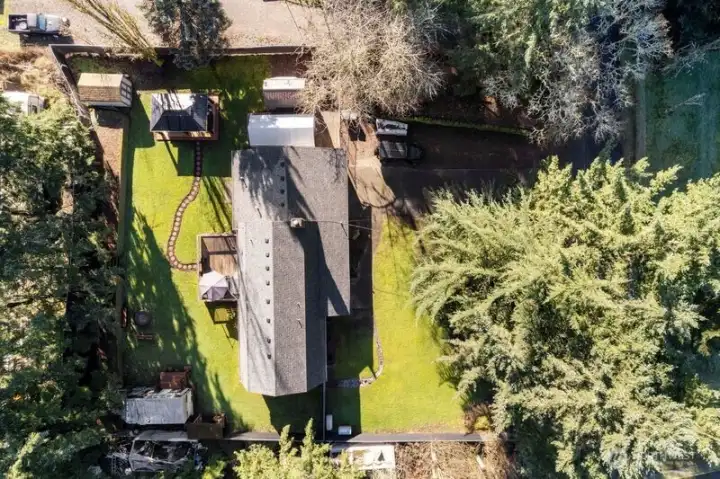 Room to Relax & Grow – This shy half-acre offers mature landscaping, towering trees, and open space ideal for gardening or simply enjoying the peaceful surroundings.