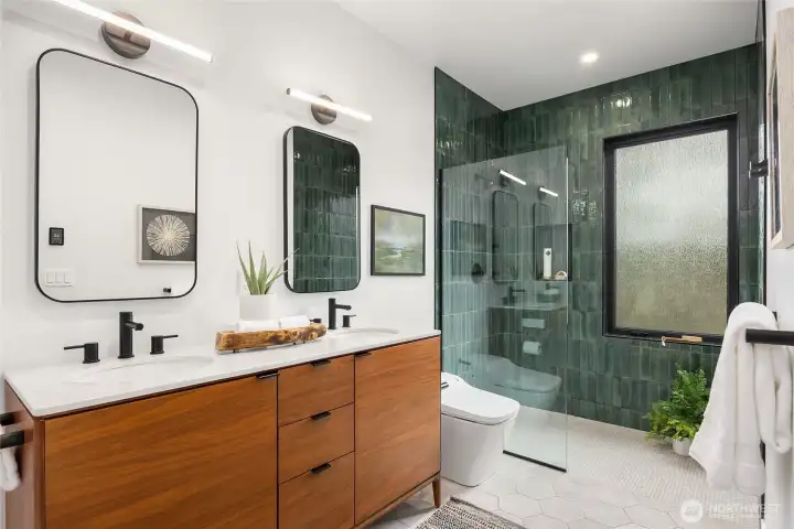 Spa-like bath has a dual sink vanity from West Elm, heated floors and a large walk-in tiled shower.                        Double sink vanity from West Elm
