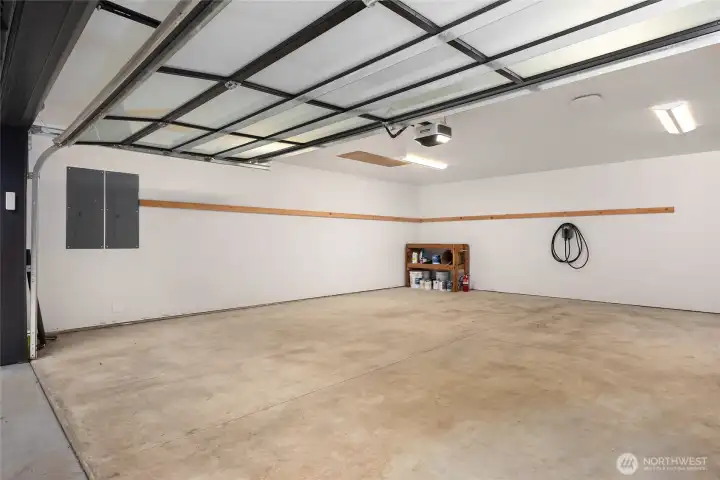 Oversized detached two car garage with electric car charging station, storage loft and utility sink.