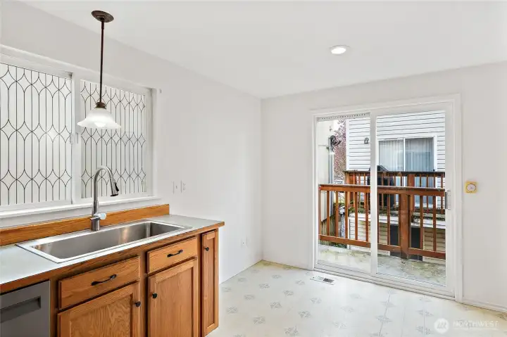 In-kitchen eating area with sliding glass doors to deck.