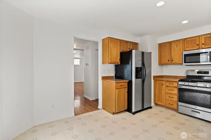 Leading to half bath (on right after exiting kitchen) and living room straight ahead