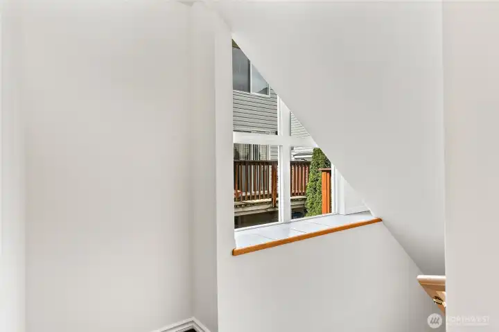 Generous windows let in great light to the entire home, ledge for displaying plants and items. Bookcase nook on landing.