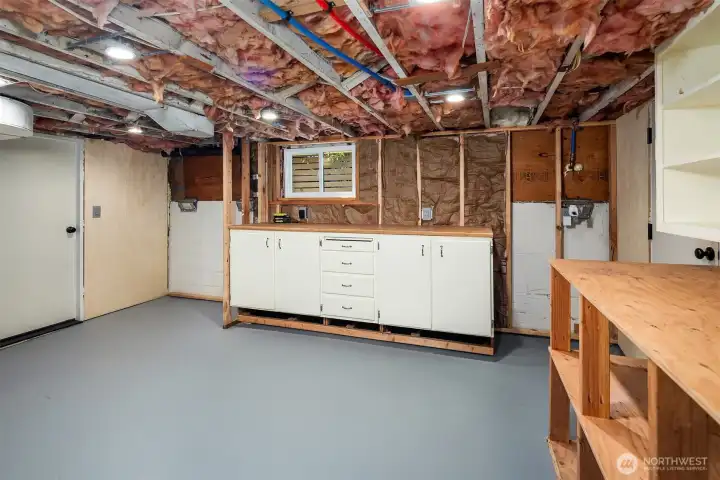 Huge unfinished basement with shop, storage, utilities, washer/dryer.