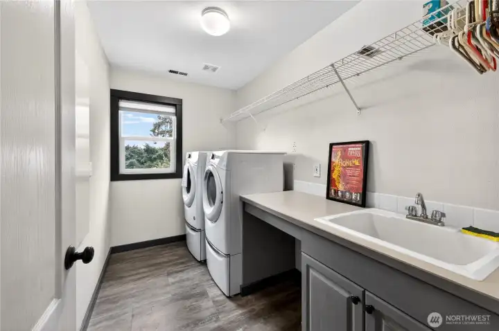 The utility room features extra storage, workspace and utility sink.