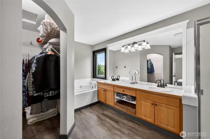 Private primary bathroom features a soaker tub, separate shower, private toilet room, and generous vanity space.