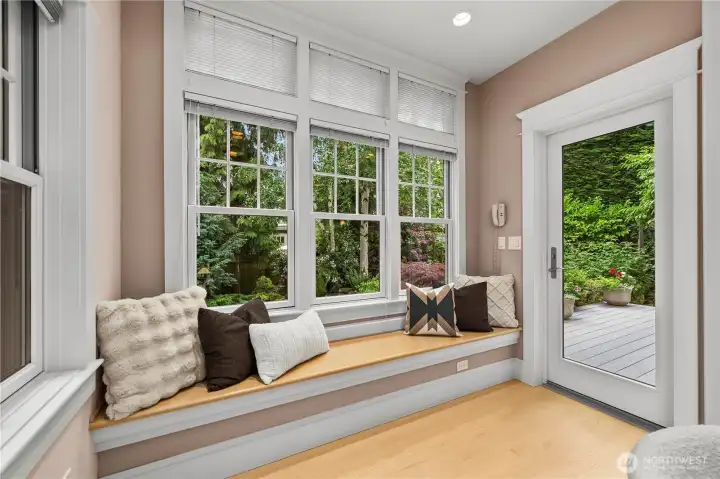 Enjoy a book or your morning up of coffee from this cozy bench that has direct access to the backyard and kitchen.