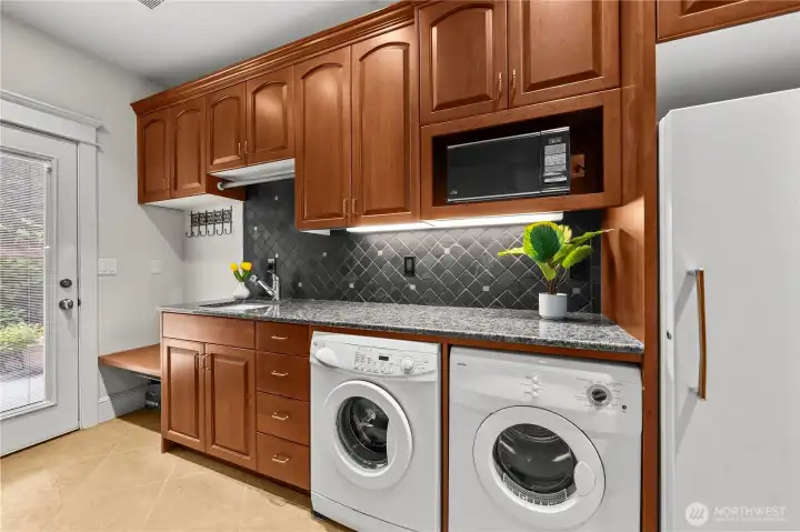 Handy mudroom with a cast iron sink, washer and dryer, microwave, AND a standing freezer that STAYS!
