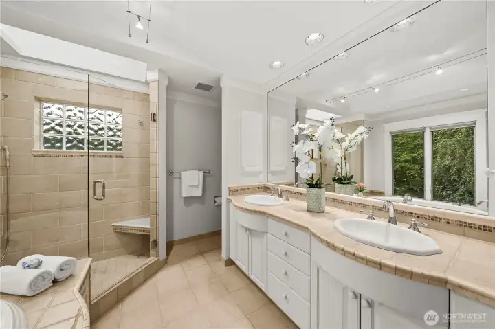 Private dual vanity sinks, standing shower, and soaking tub.