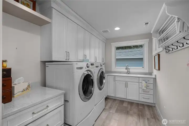 Full laundry with storage and ample space.
