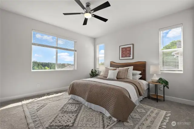 An ensuite primary bedroom offers a lovely territorial view of the neighborhood and the Cushman Trail below.