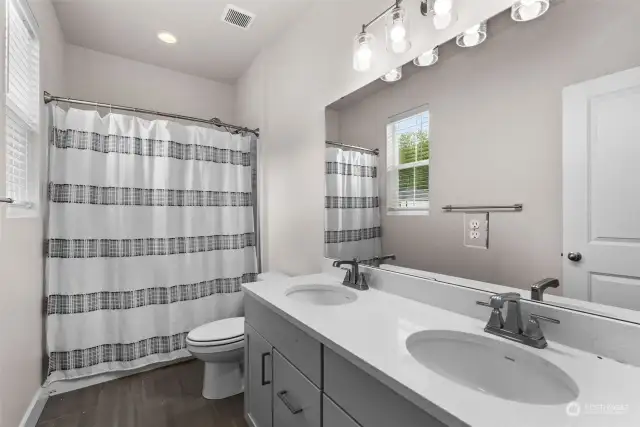 The shared full bathroom can be enjoyed by the surrounding junior bedrooms located just steps away.