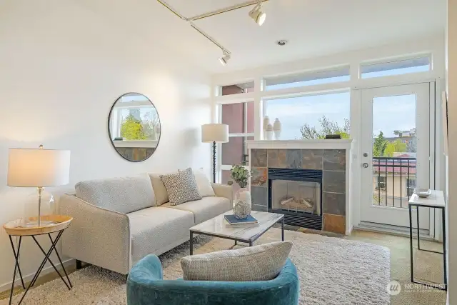 High ceilings and a wall of windows flood the home with natural light.