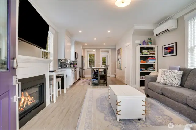 The open floor plan provides easy entertaining options for you and your guests. The low maintenance luxury vinyl flooring adds to the style and continuity of the flow of this space. Notice the tall ceilings, crown molding throughout, and clear sightlines to the privacy of the back of the home.