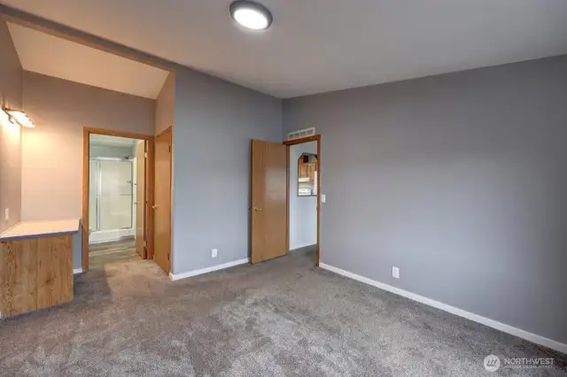 Primary Suite with walk in closet, primary bath and lighted make up vanity table