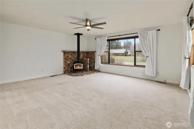 Primary bedroom is so spacious and offers a wood stove for cozy nights!