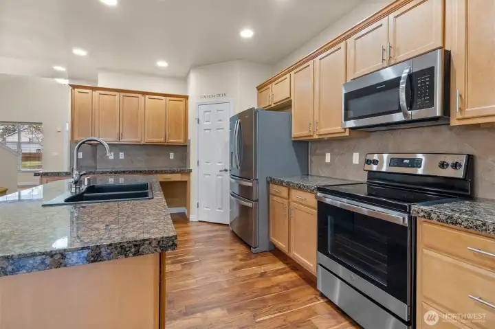 Granite surfaces, stainless finishes, and timeless details throughout