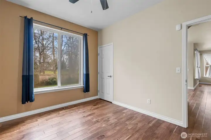 Main-floor bedroom with peaceful greenbelt views