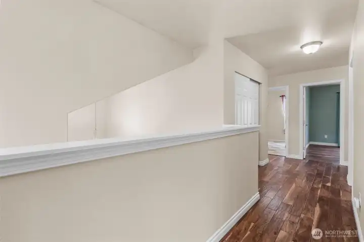 Acacia hardwoods continue through the upper level, creating warmth and seamless flow between bedrooms