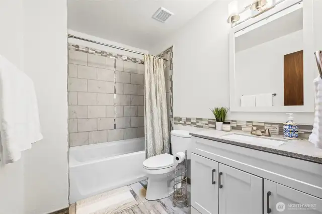 Up the stairs to the left is the updated full bathroom