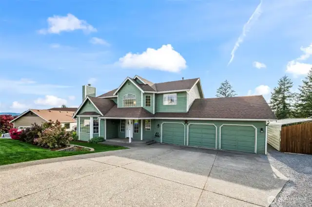 Expansive driveway, 3 car garage, RV parking & additional storage