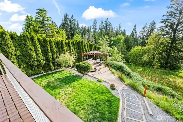 Looking down from the deck to the entertaining space with gazebo and firepit