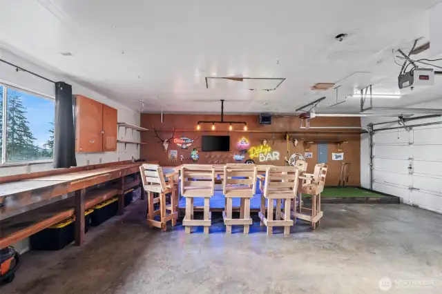 3 car garage already set up for entertaining. Work bench and storage