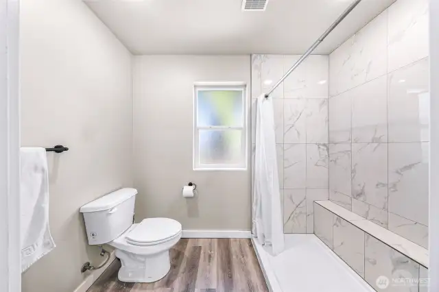 Primary bath has separation for privacy from vanity and closet for the large shower and toilet
