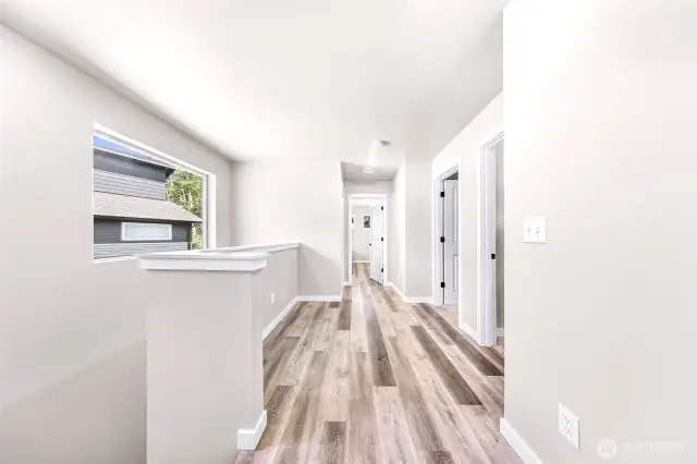 Upper level hallway access to all bedrooms, bath and utility room - just filled with natural light!