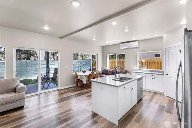 Living and kitchen area are open concept, kitchen has eating bar