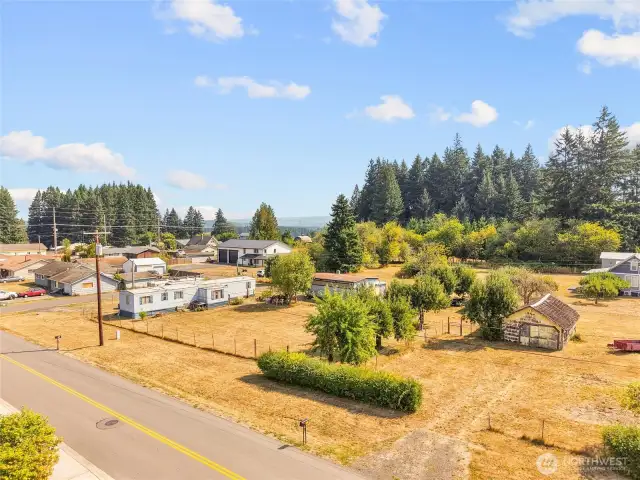 Lot is sided by paved roads on 3 sides.