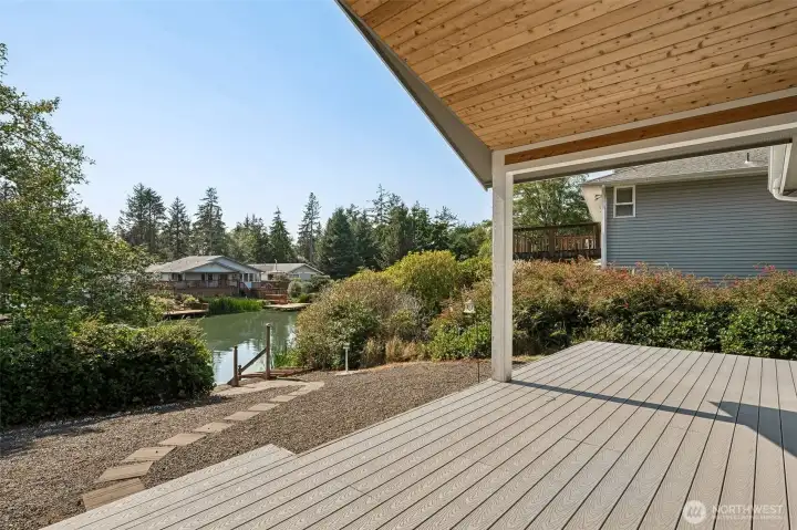 Pavers path leads you around to the backyard featuring a spacious deck inviting you to the beautiful waterfront view!