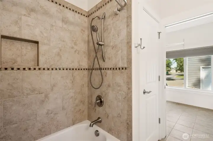 Tiled walls in second ensuite bathroom with linen closet