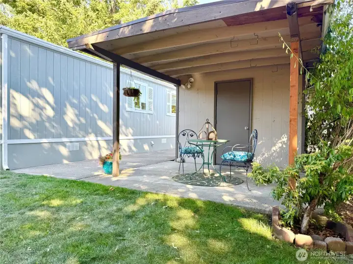 Covered patio next to storage shed