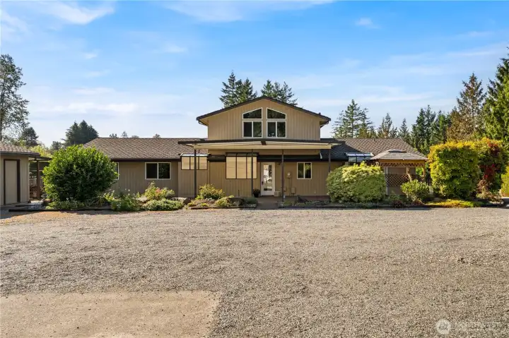 Expansive drive and parking with adjoin 2 car garage and covered storage area