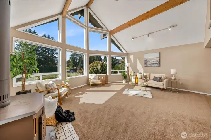 Great open family with exposed beams, abundant windows and stand alone wood stove