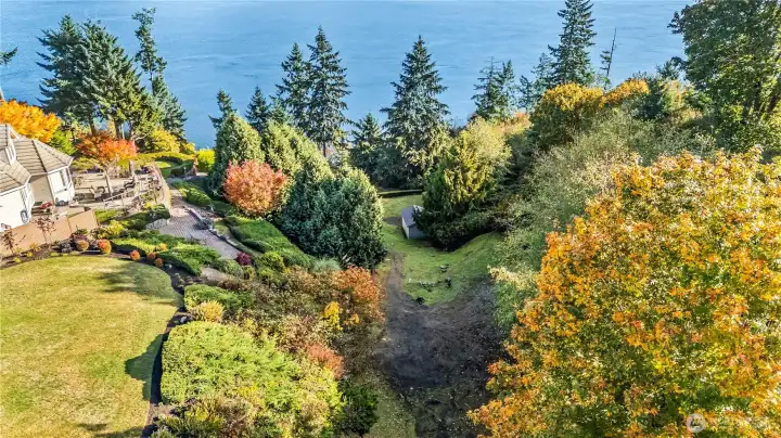 View looking down the parcel. Some land exists off to the right where trees exist. With a current survey it may be possible to open up the view more.