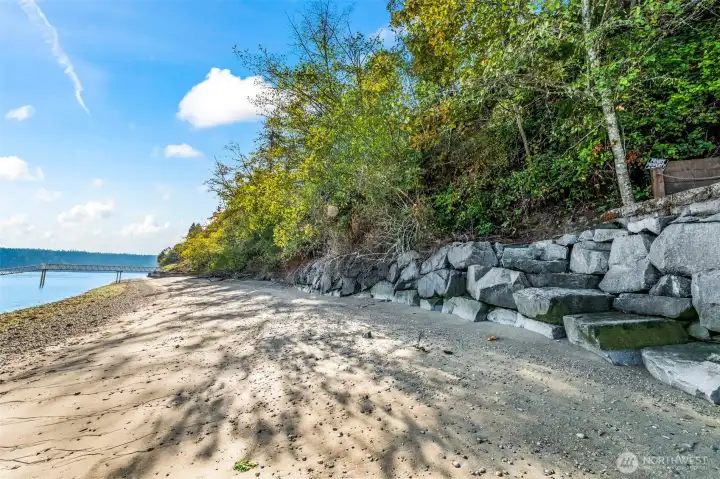 View of large stone bulkhead and just a few stone steps to the beach. View of large stone bulkhead and just a few stone steps to the beach.