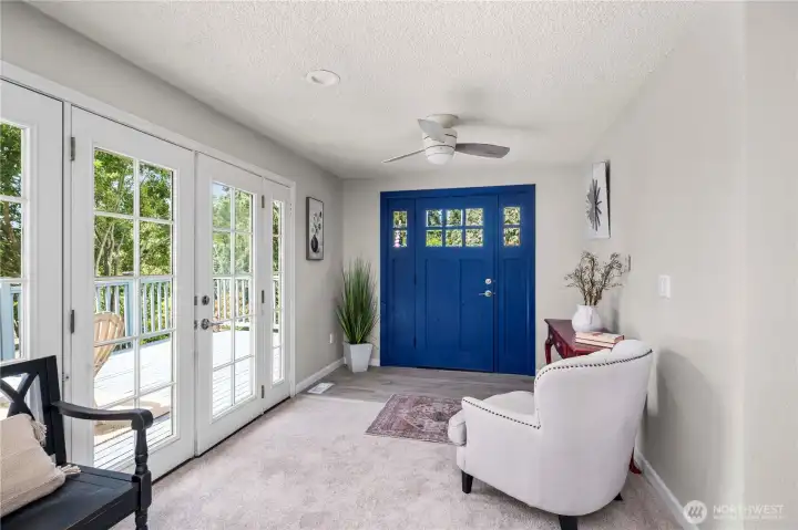2 french doors allowing access to the deck and allows wonder light to fill the home