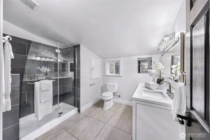 Upstairs remodeled bath with double vanity and quartz counter.