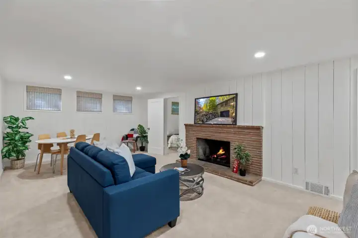 Downstairs living room w/wood burning fireplace.