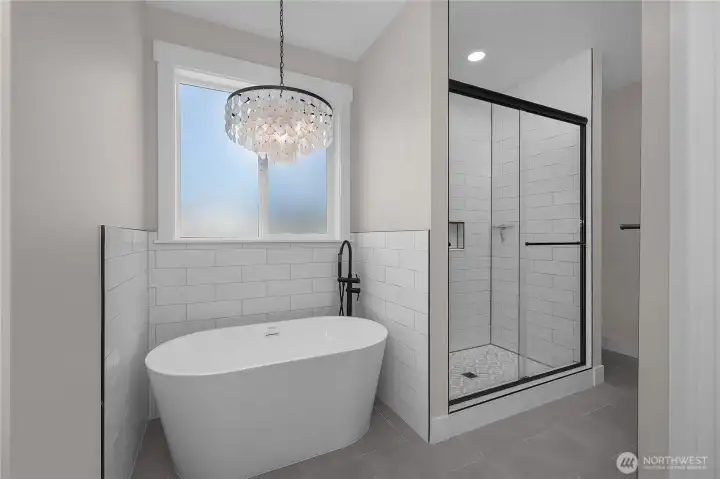 Beautiful Modern Freestanding tub with tiled walk-in shower.