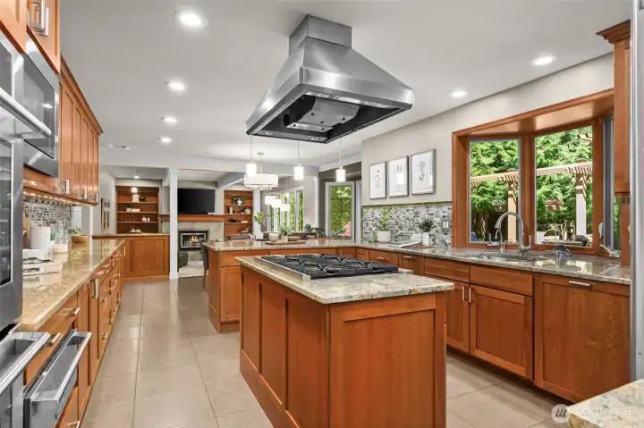 This dreamy kitchen  has it all- double oven, gas cooktop, extensive cabinetry, gorgeous countertops, and all the prep space you could need