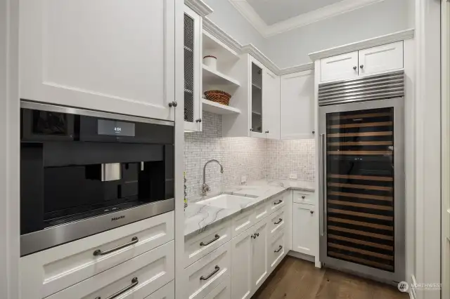 The adjacent scullery kitchen with built in espresso maker, wine cooler and oversized pantry make every morning and entertaining.