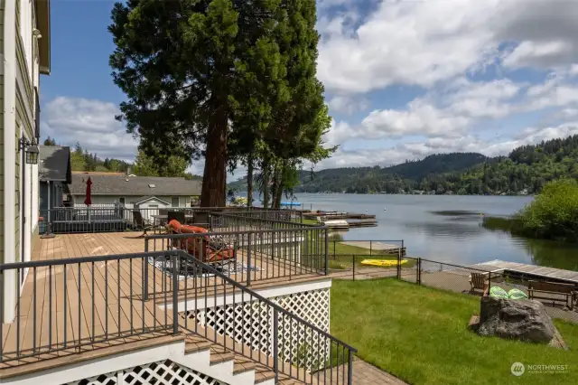 What a place to enjoy relaxing days at the lake house . . . all year round!  What a lovely deck overlooking the yard, dock and lake beyond.